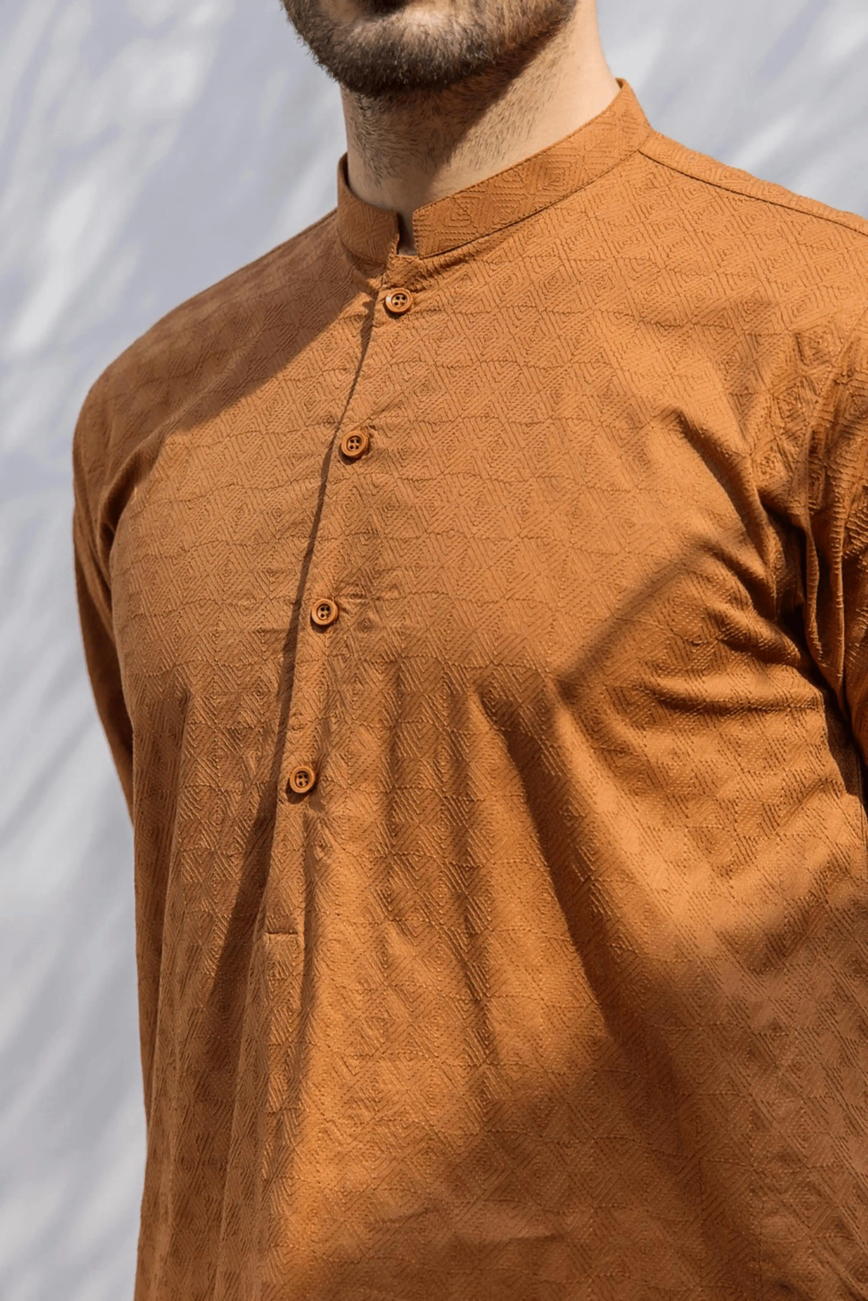 Close-up of a brown traditional kurta tailored for occasion wear